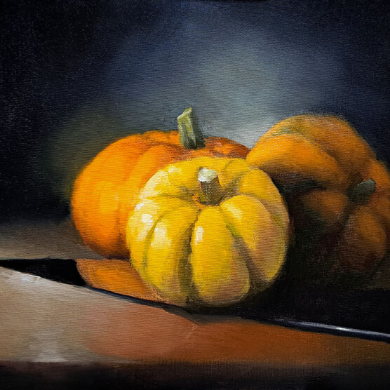 An oil painting of three orange pumpkins sitting on top of a shiny knife.