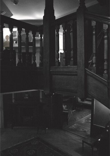 Black and white image of stairs landing in Limnerslease house