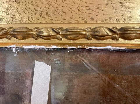 Frame being filled using a conservation-grade chalk-based filler