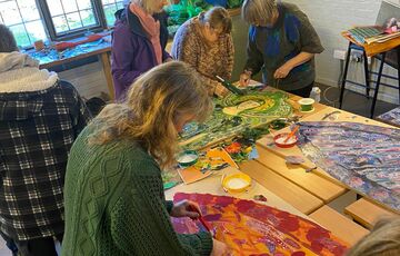 A group of volunteers gathered in the Foyle collaging the phone box angels