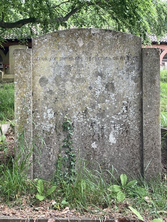 a large grave stone monument sitting in the middle of a field