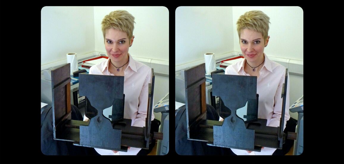 Stereoscopic photograph of a woman holding Charles Wheatstones 1838 mirror stereoscope
