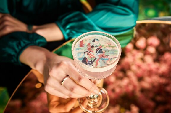 A woman holds a champagne cocktail