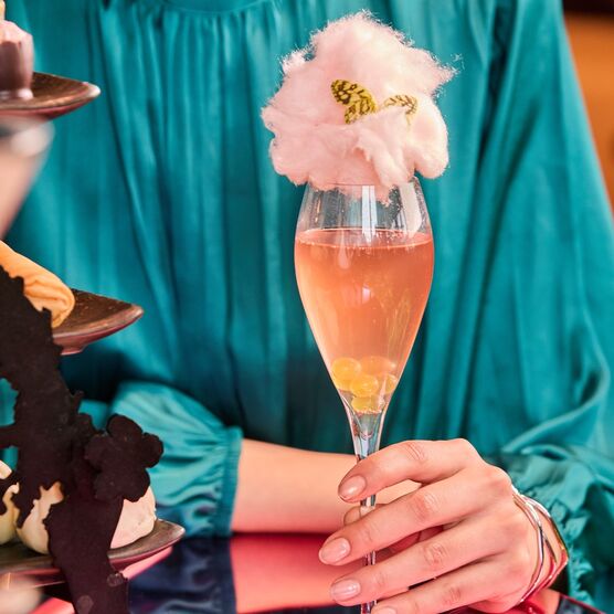 A woman holds a champagne cocktail