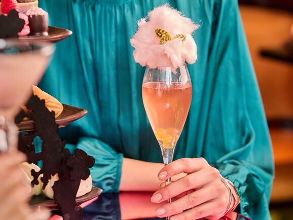A woman holds a champagne cocktail