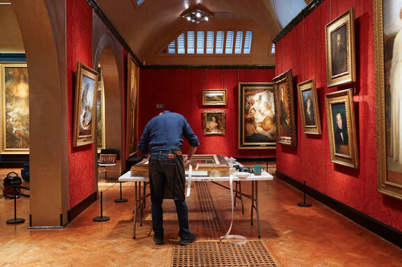 Frame conservator Tom Proctor working on Virginia Dalrymple's frame at Watts Gallery. His back is facing the camera