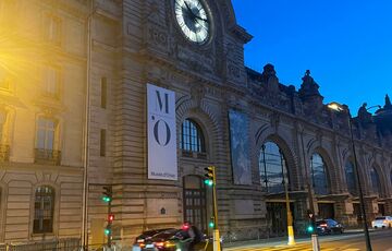 A photograph of the Musee D'Orsay in Paris at night.