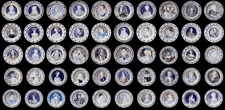 Photo of a series of dinner plates featuring portraits of women using blue pigment.