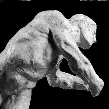 Black and white image of sculpture with black background