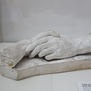 A cast of two hands holding