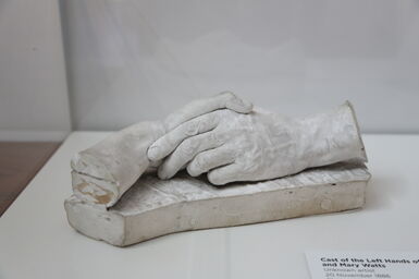 A cast of two hands holding