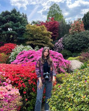 Lottie stands in a garden