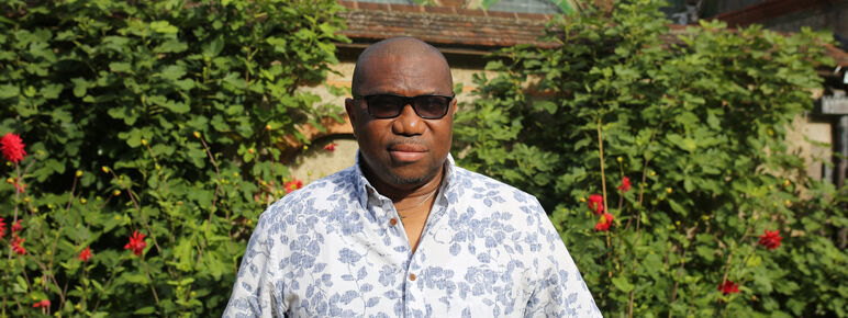 Henry stands outside the gallery looking at camera