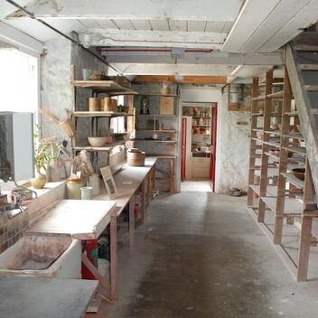 Photo of a small pottery studio with low ceilings