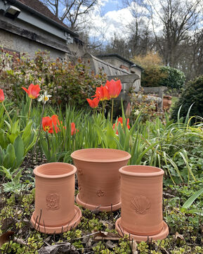 Three hand-thrown terracotta pots with symbol on the front