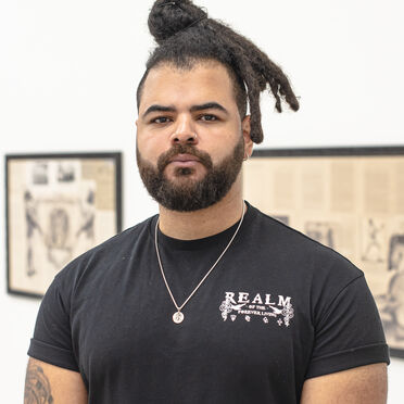 Habib, a young man wearing a black t shirt, looks into the camera