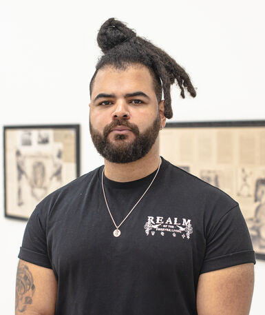 Habib, a young man wearing a black t shirt, looks into the camera