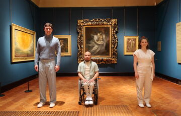 The dancers in Chris Pavia's Into the Waves stand in a line in the Historic Gallery in front of Francesca and Paolo