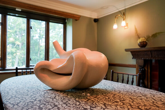 Photo of a white abstract ceramic sculpture placed on a dining room table