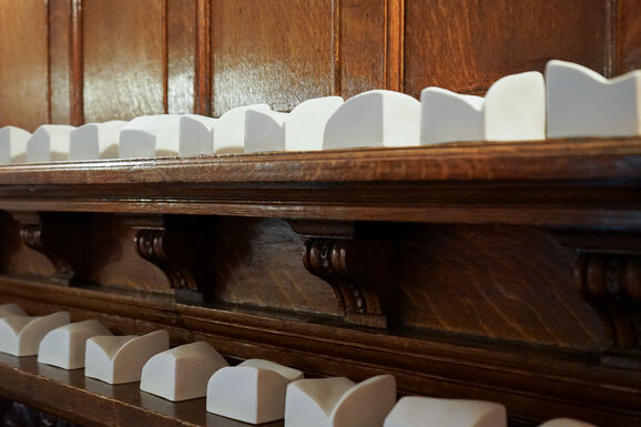 Close-up photo of small porcelain sculptures on a mantlepiece