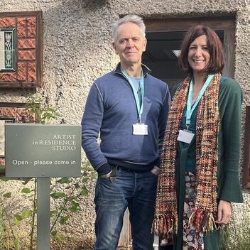 A man with grey hair, Joseph Young, and a lady with short brown hair, Kay Aplin
