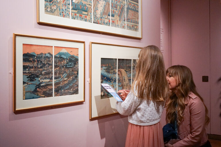 Photo of a mother and daughter in the Edo Pop exhibition at Watts Gallery doing the eye spy activity sheet