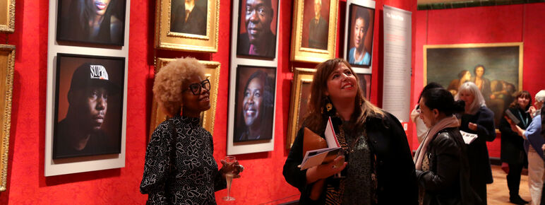 Two visitors look at art in Historic Galleries