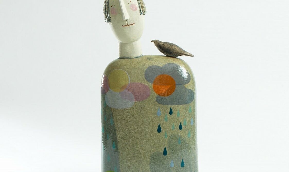 An abstract figure of a woman with a bird on her head and one on her shoulder