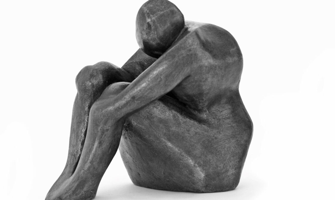 An abstract figure curled up with arms up to her chest