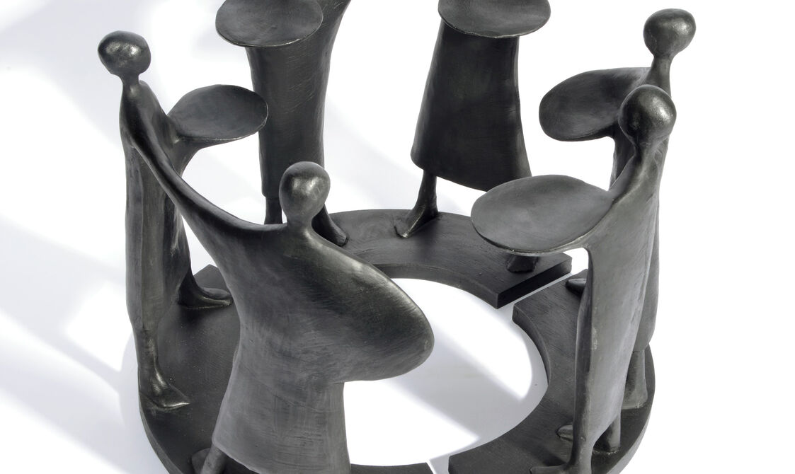 Six black abstract figures arranged in a circle