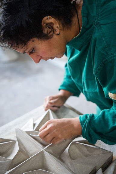 Halima Cassell working on an artwork