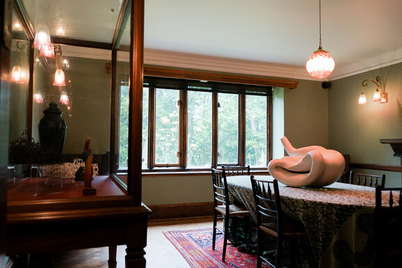 Photo of a white abstract ceramic sculpture placed on a dining room table
