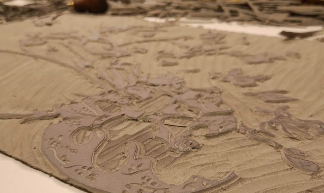 Carved piece of lino depicting a layer of Carnations