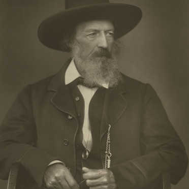 Sepia toned photograph of Alfred, he wears a smart jacket and wide-brimmed hat