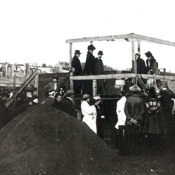 Archive photograph of G F Watts surrounded by the local community in Compton laying the foundation stone to Watts Gallery