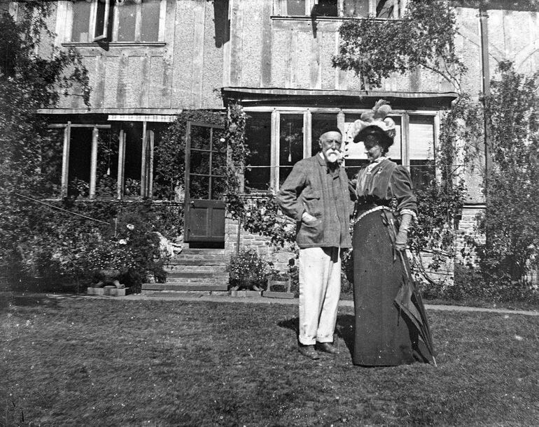 Black and white photo a couple outside their home