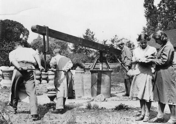 Black and white photo of workers operating mill
