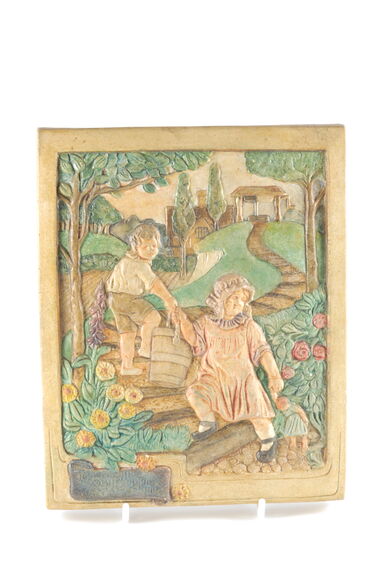 Pottery relief of two cherub-like figures working in a cottage garden