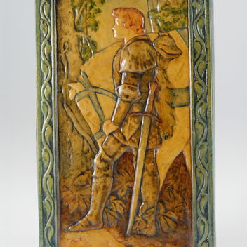 Yellow toned ceramic plaque with a knight and horse