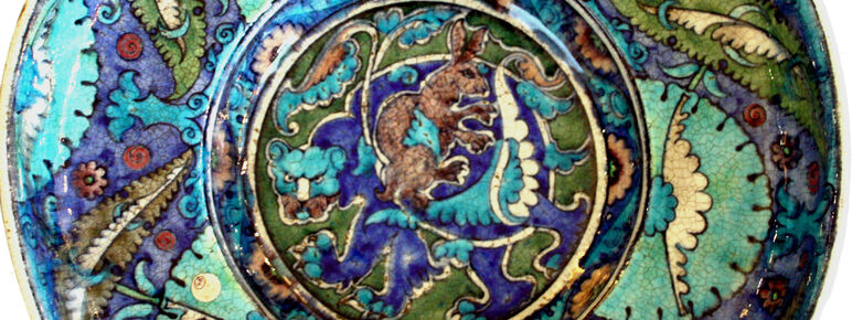 An intricate decorative dish in hues of blue, purple and green.