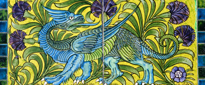 A set of decorative tiles depicting a blue dragon on a yellow background surrounded by purple flowers and green stalks