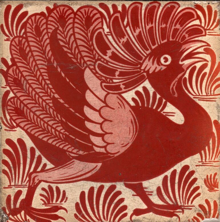 Ruby Luste earthenware tile with a peacock in front of a tufted background. On an engobe ground.