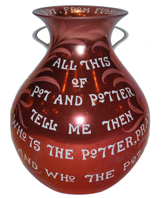 Ruby lustre has been used over the entire surface of this vase, with added ornamentation with the use of pink willow leaves and white writing. Inscribed on the vase are the words ALL THIS OF POT AND POTTER TELL ME THEN WHO IS THE POTTER, PRAY AND WHO THE POT from The Rubaiyat of Omar Khayyam.