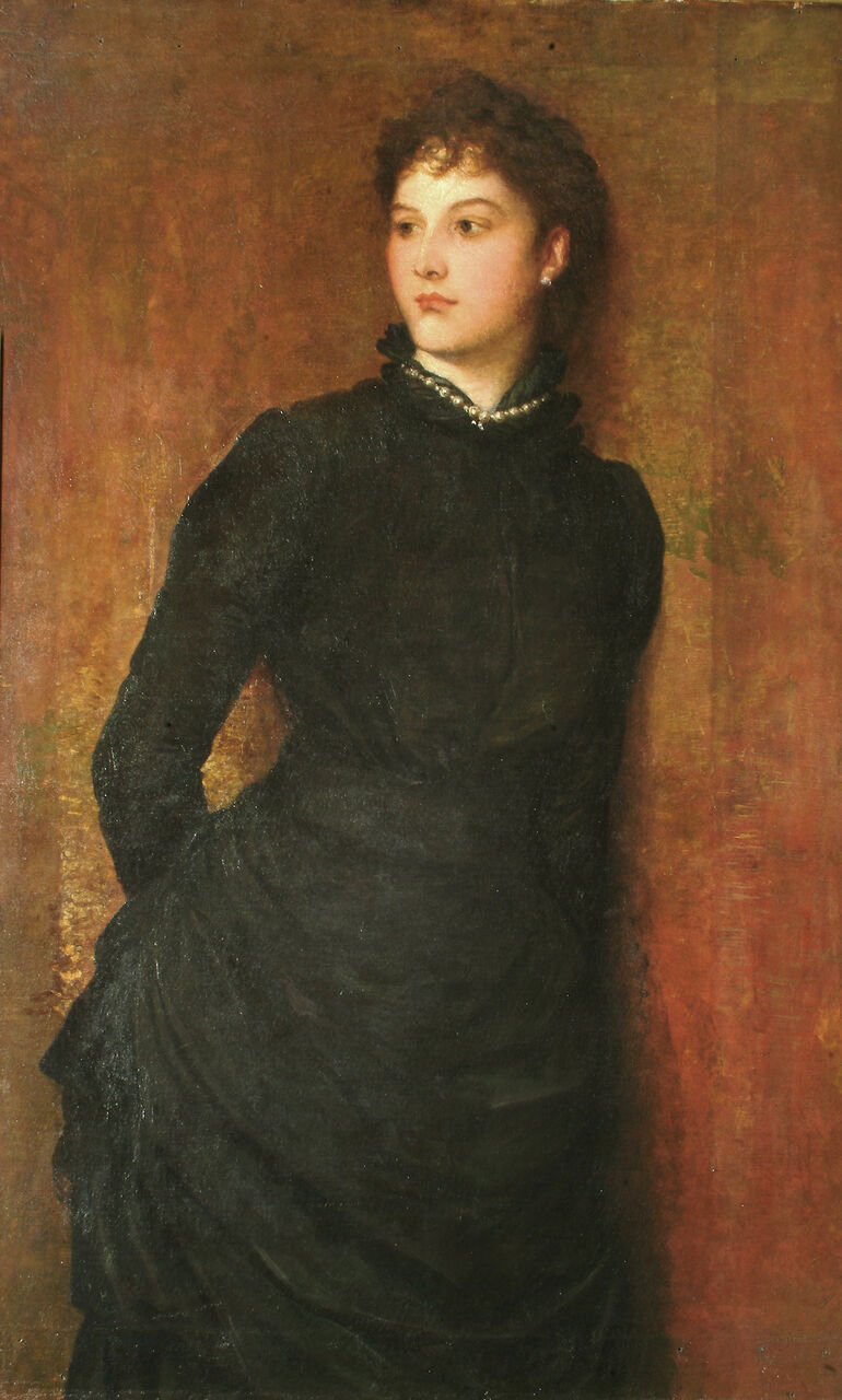 Portrait of a women with her head to the side in a dark long-sleeved dress