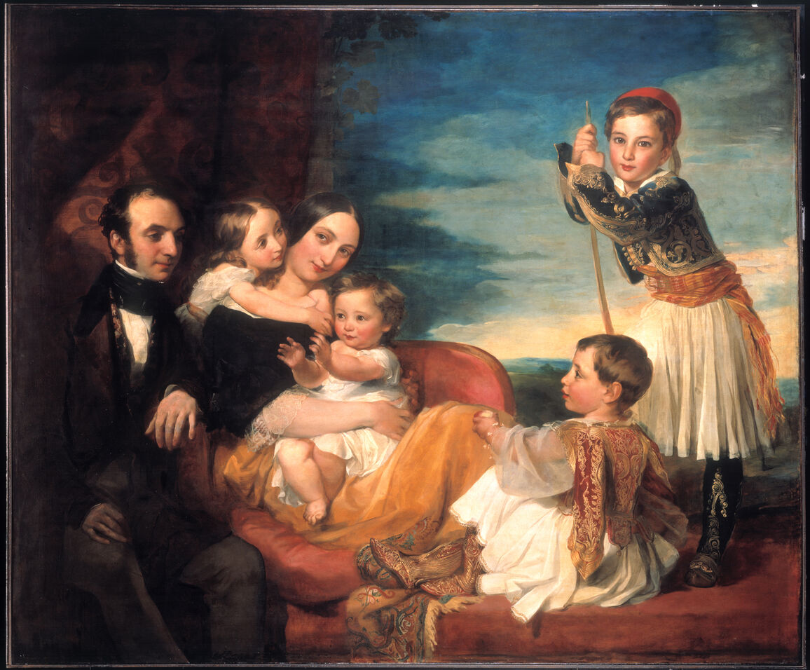 a couple posed with their four children around them