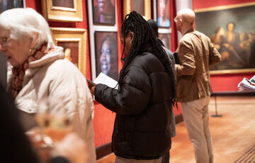 A photograph of a group of people during the opening of exhibition Faces of Fame within the Historic Galleries
