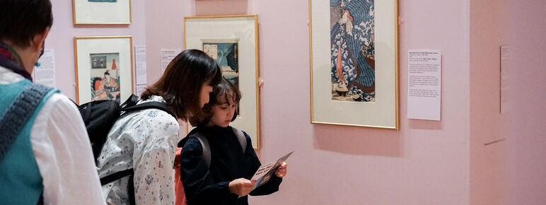 Mother and child in the Edo Pop exhibition at Watts Gallery, looking at an eye spy activity sheet