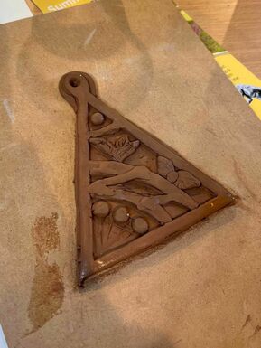 Triangle pendant made from clay