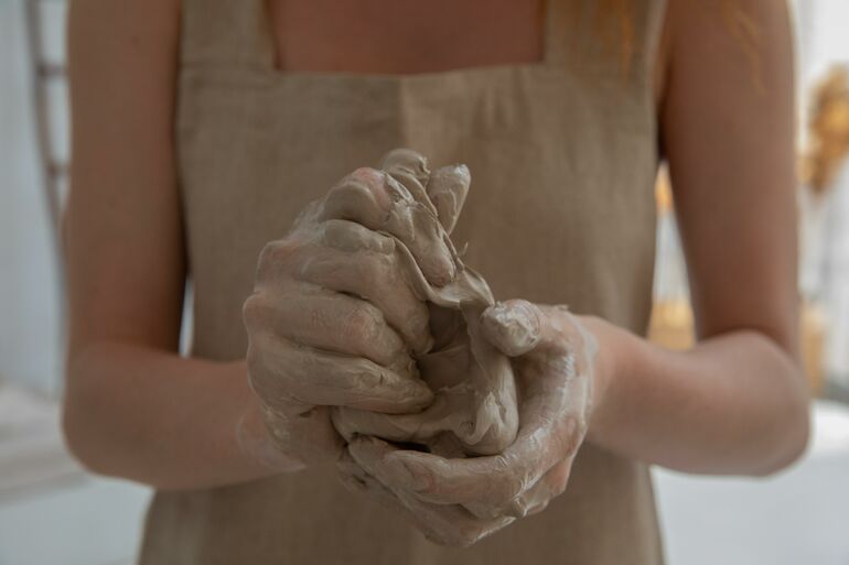Close up of a pair of female hands working with clay