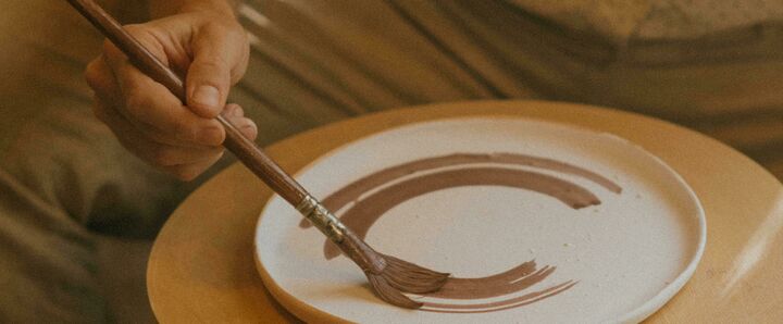 Someone painting ceramics